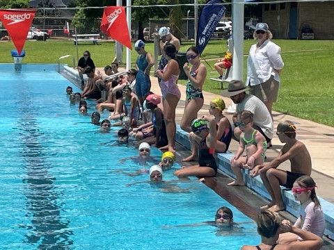 Scooter and swimmers in pool Scooter and swimmers in pool