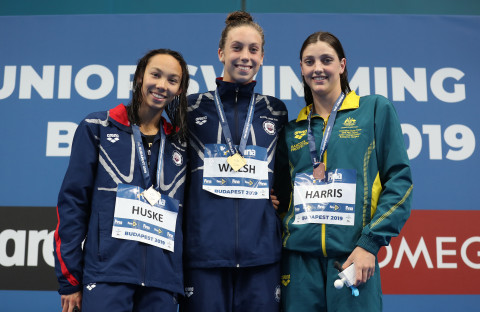 Meg Harris proudly stands on the podium with the USA duo.