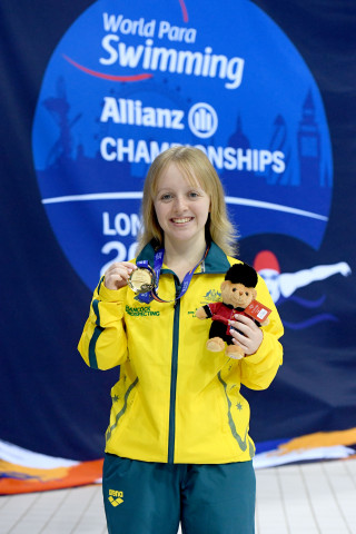 Thomas Kane proudly poses with her gold medal.